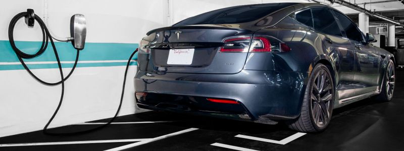 A TESLA plugged into a charging station at the Sunset Marquis in their Electric Vehicle garage. 