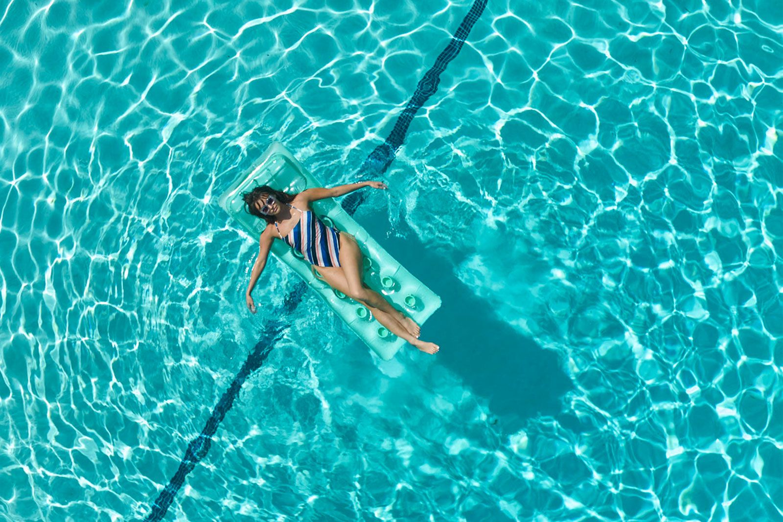 Person floating in tranquility at the Sunset Marquis suites pool
