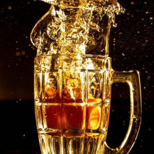 Beer Splashing Out of Glass