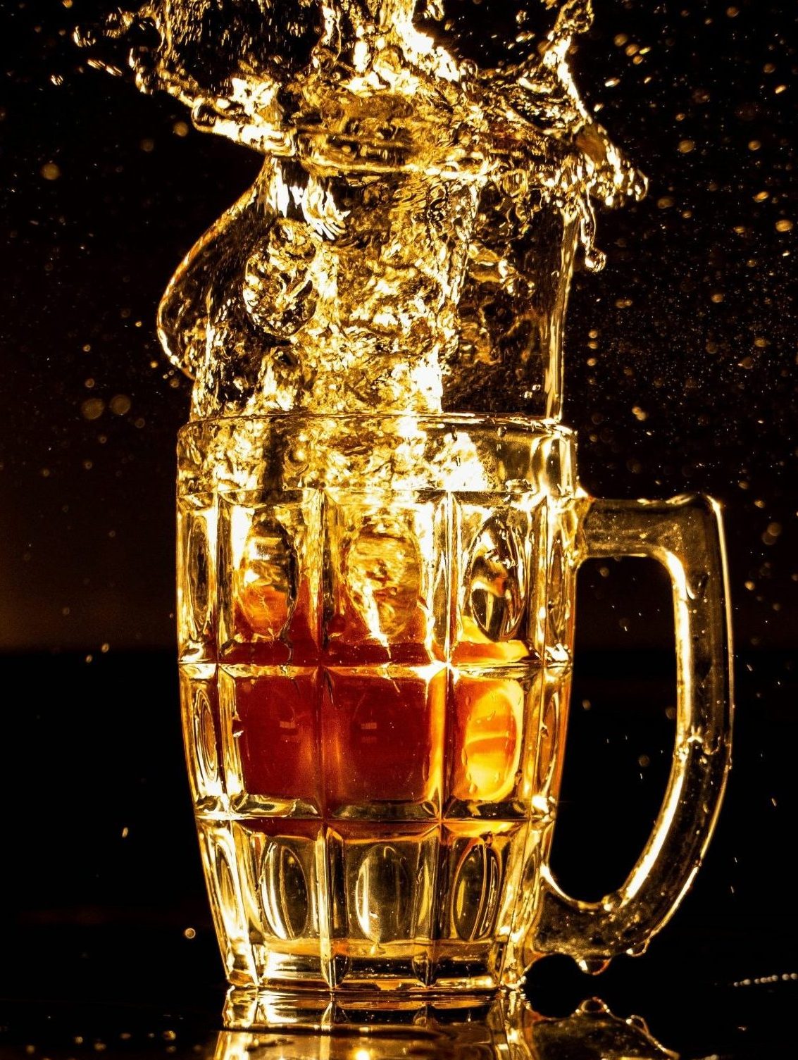 Beer Splashing Out of Glass