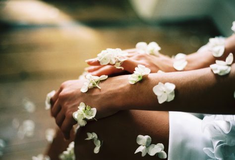 Woman with Little, White Flowers on Her Arms