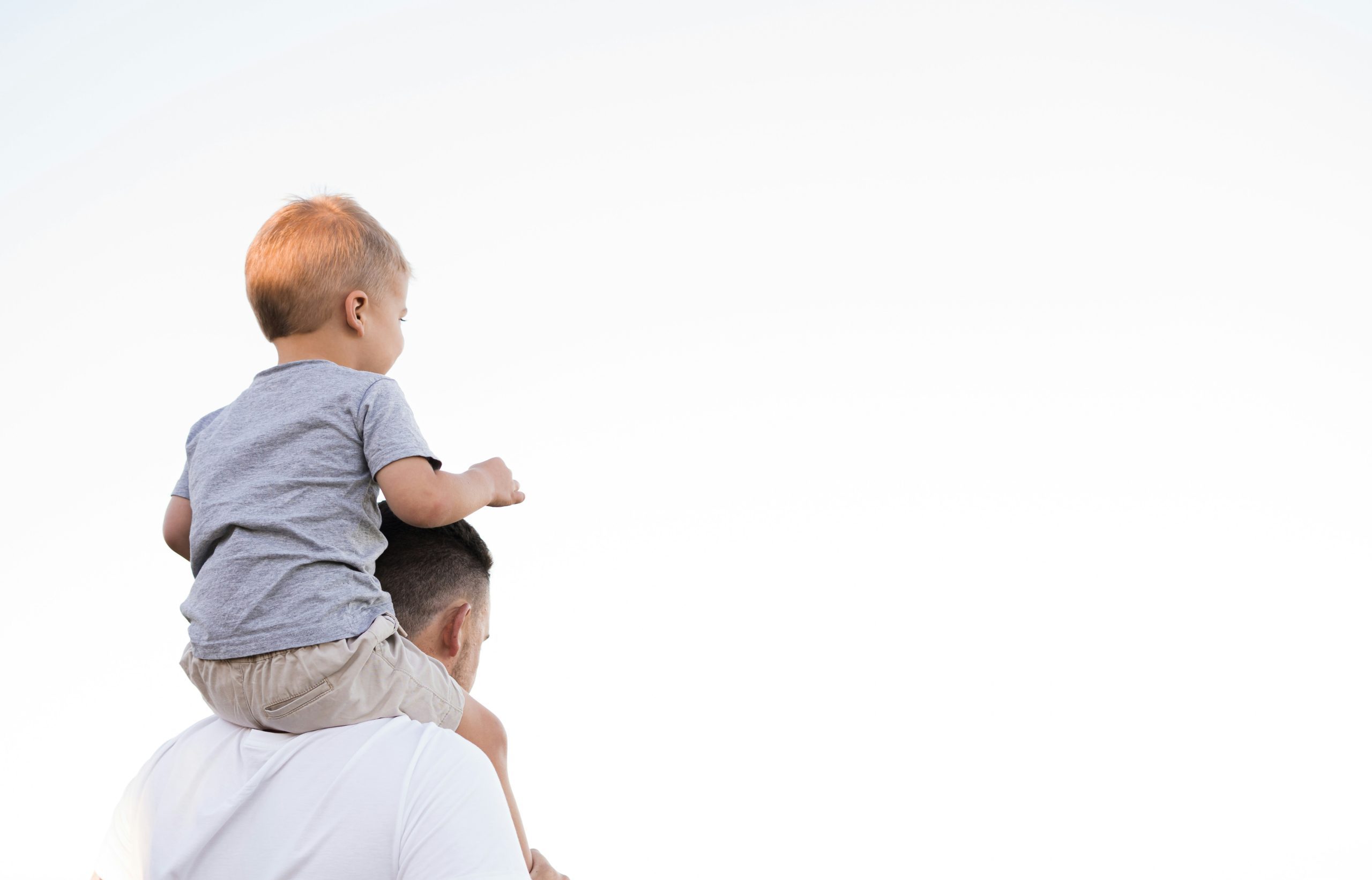 Father Holding Child on His Shoulders