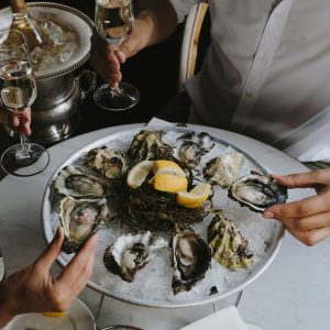 Two People Enjoying Oysters and Wine